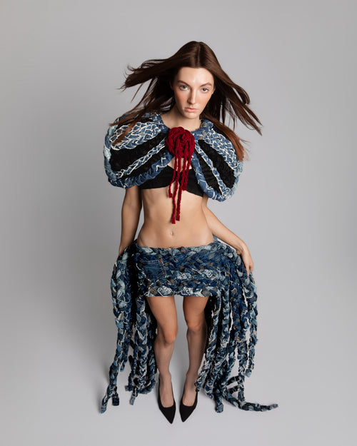 KROMANOX ART001 Braided Bloom Cape and ART002 Braided Bloom Skirt in motion, showing layered braided denim movement and texture