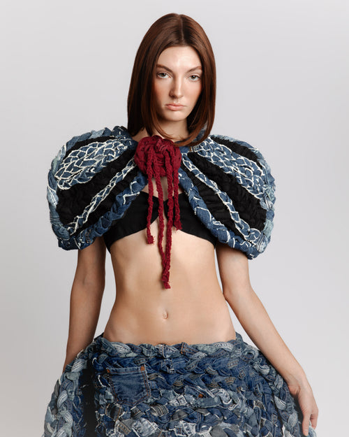Detail of layered braided denim creating volume on KROMANOX ART001 Braided Bloom Cape and ART002 Braided Bloom Skirt