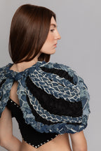Detail of frayed denim texture and braided construction on ART001 Braided Bloom Cape