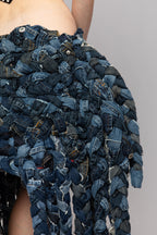 Detail of frayed denim texture and braided construction on ART002 Braided Bloom Skirt