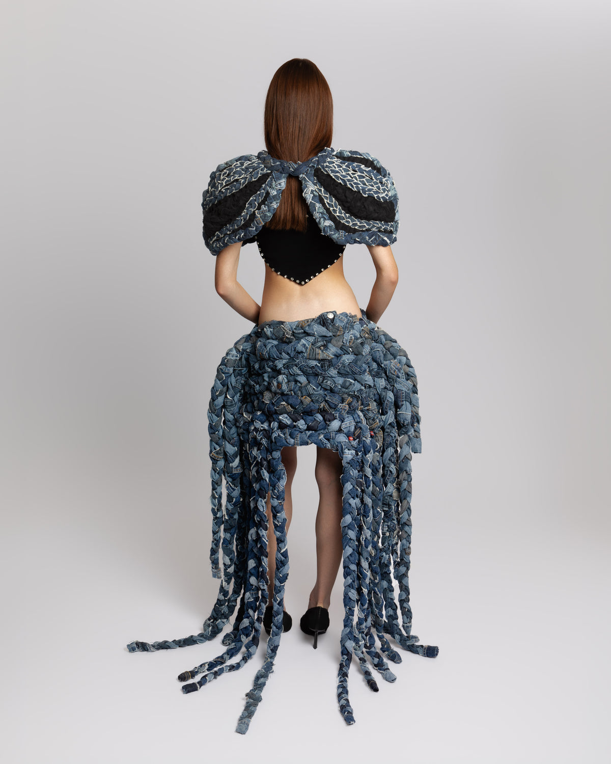 Back view of KROMANOX ART002 Braided Bloom Skirt and ART001  Braided Bloom Cape with hand-braided reconstructed denim